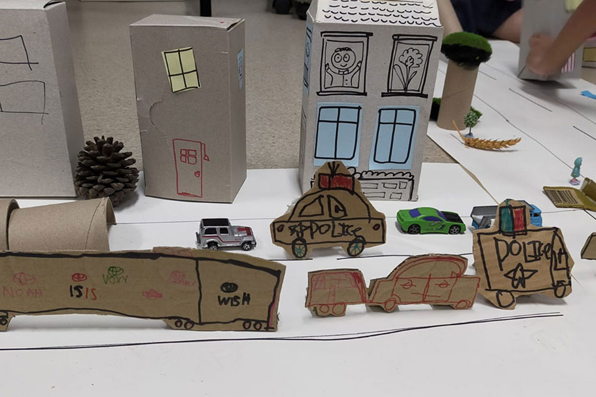 Installations of buildings and police cars made from boxes