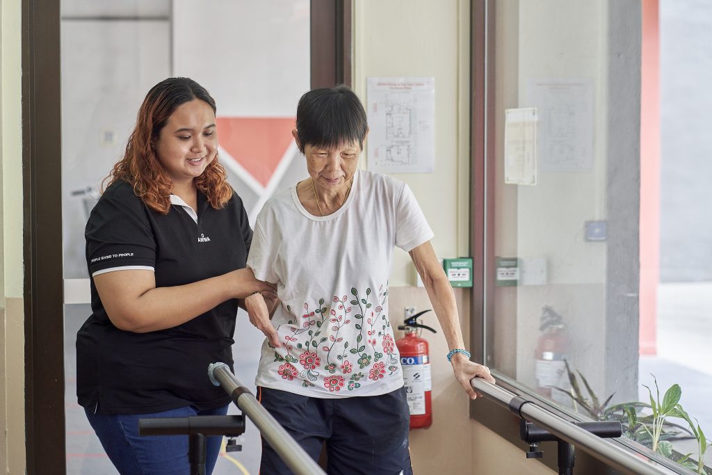 AWWA staff member standing with an elderly participant