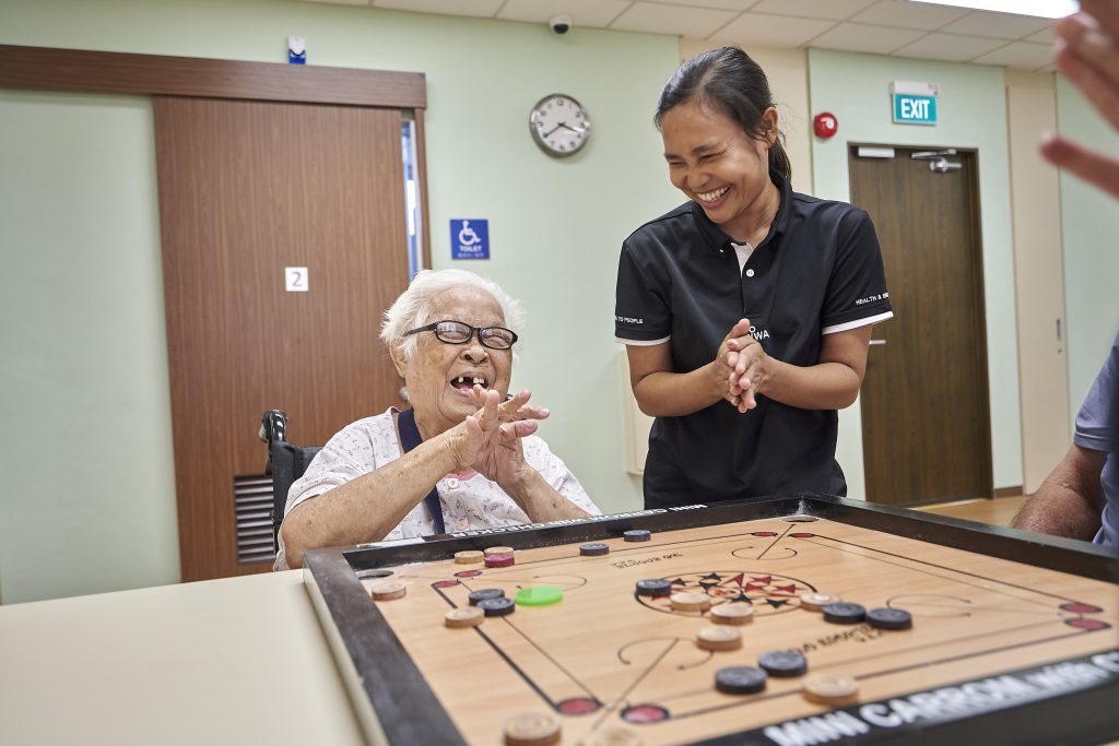 AWWA staff member standing with an elderly participant