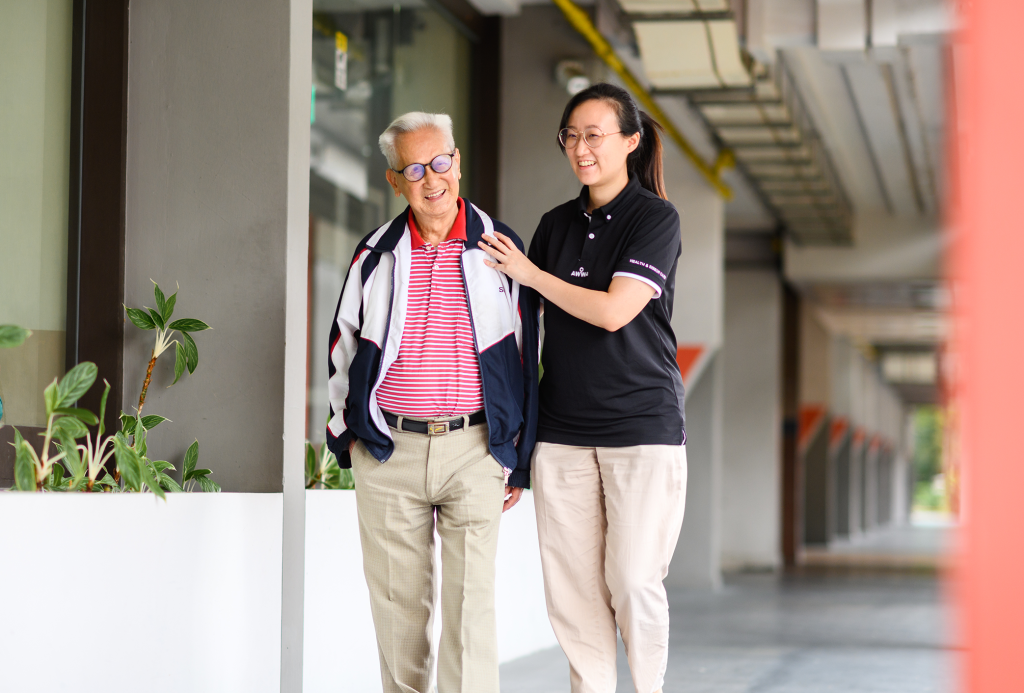 AWWA staff member standing with an elderly participant