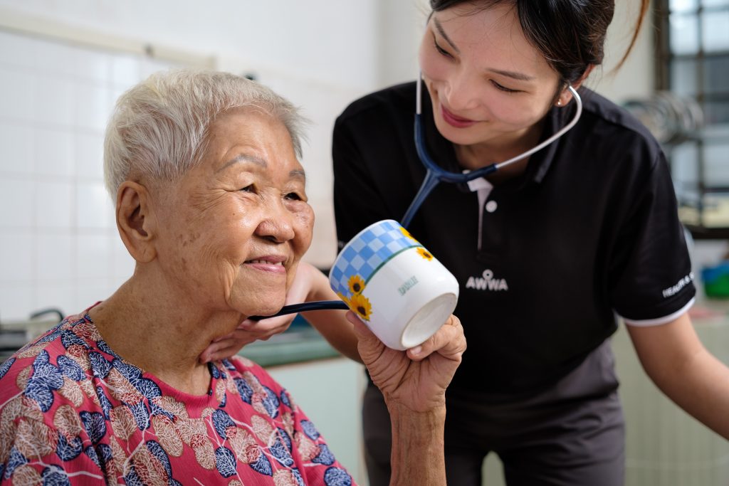 AWWA staff member standing with an elderly participant