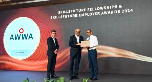 3 men standing on an awarding ceremony in a stage at skills future fellowship & skillsfuture employer awards 2024