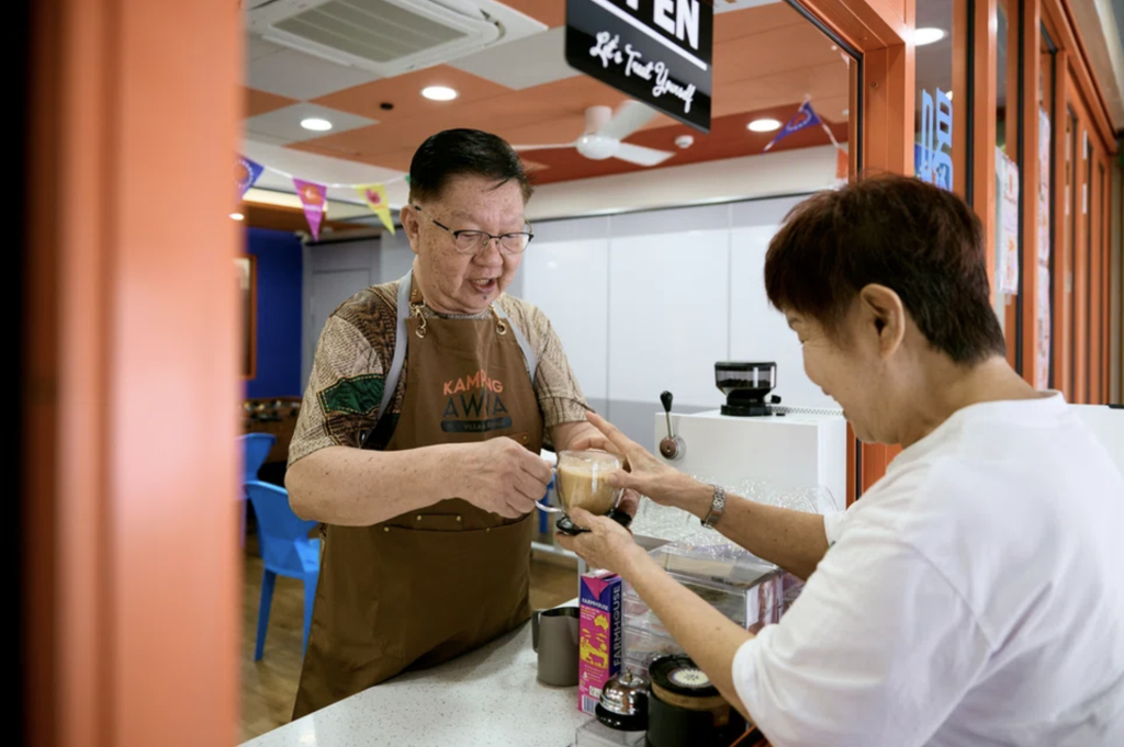 Mr Koh Kong Kuan serving coffee at Kampung AWWA