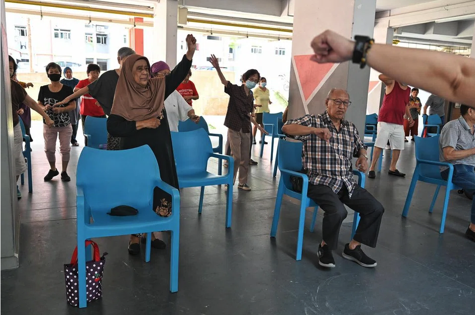 Seniors exercising at the void deck