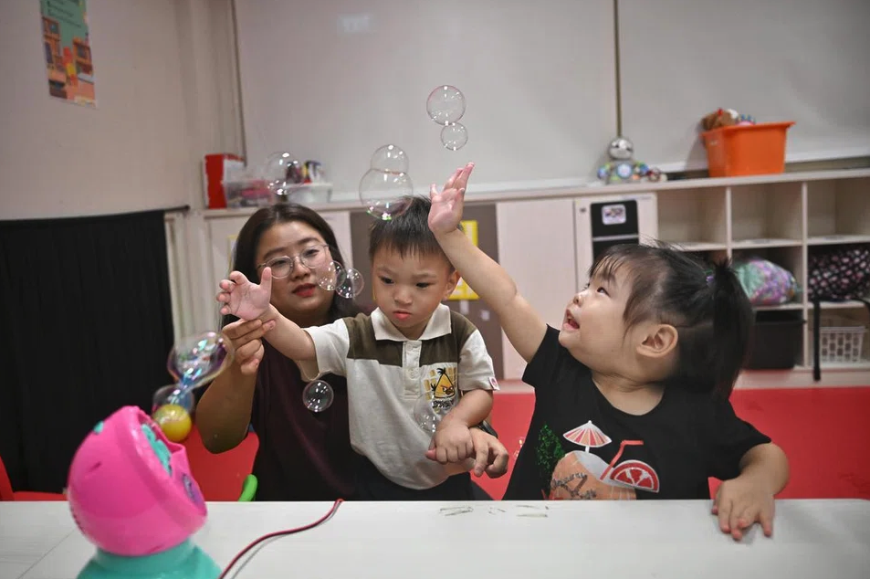 Cheryl with children playing with adaptive toys
