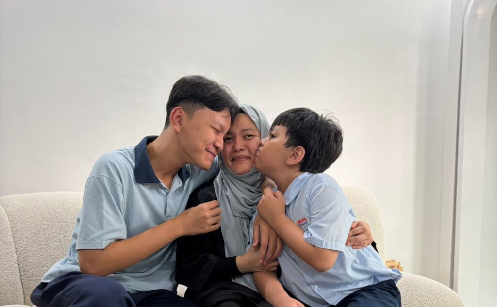 Ms. Noreen Malyssa Noor Affandi posing with two of her sons