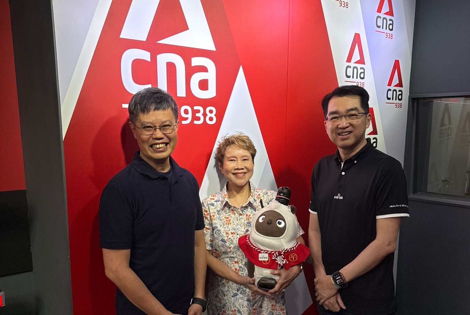 Dr Kelvin Tan, Mr Sean Tan, and a LOVOT posing for an interview with Susan Ng
